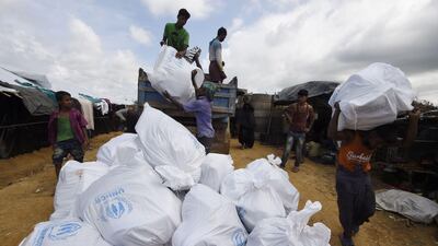 Rohingya refugees recieve UN relief supplies at the Kutupalong refugee camp on Sunday. Dominique Faget / AFP