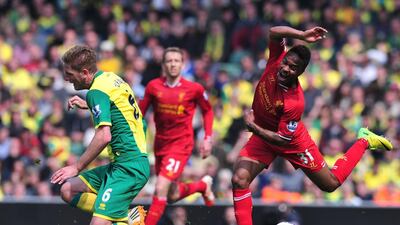 Liverpool midfielder Raheem Sterling vies for the ball with Norwich City defender Michael Turner during their Premier League football match at Carrow Road in Norwich. Carl Court / AFP / April 20, 2014