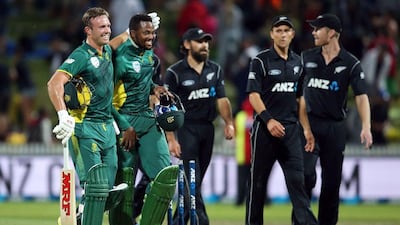 AB de Villiers of South Africa, left, and his teammate Andile Phehlukwayo celebrate winning the one-day international (ODI) cricket match between New Zealand and South Africa at Seddon Park in Hamilton on February 19, 2017. Michael Bradley / AFP