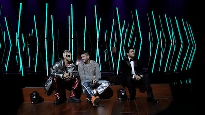 Jhay Cortez and Bad Bunny with host Trevor Noah during a prerecorded segments ahead of the the 63rd Grammy Awards filmed at the Los Angeles Convention Centre on Sunday, March 7, 2021. AP Photo