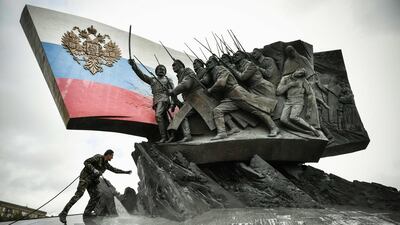 A worker washes a Monument to the Heroes of the WWI at the Poklonnaya Hill in western Moscow, Russia. AFP