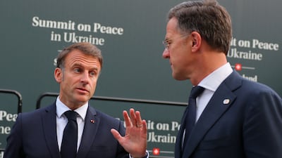 French President Emmanuel Macron speaks with Dutch Prime Minister Mark Rutte. Reuters