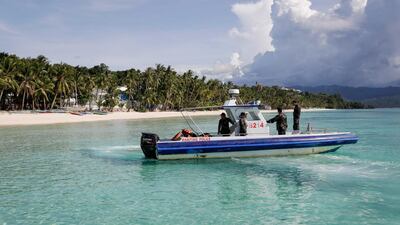 Maritime police on patrol on the first day of a test-run allowing tourists to return to Boracay. Photos by Mark R Cristano / EPA