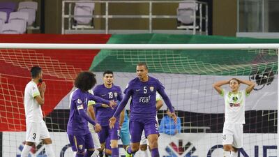 Ismail Ahmed, centre, is congratulated by his Al Ain teammates after his equaliser against Zobahan. Jeffrey E Biteng / The National
