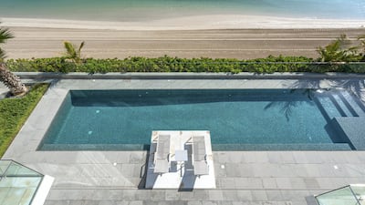 The pool is set in a stone deck and overlooks the sea