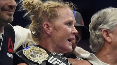 Holly Holm holds the champion belt after defeating Ronda Rousey during their UFC 193 bantamweight title fight in Melbourne, Australia, Sunday, Nov. 15, 2015. Holm pulled off a stunning upset victory over Rousey in the fight, knocking out the women's bantamweight champion in the second round with a powerful kick to the head Sunday. (AP Photo/Andy Brownbill)
