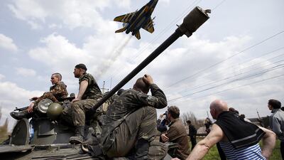 In this 2014 photo, Ukrainian soldiers sit on an armoured personnel carrier in Kramatorsk. Ukrainian government forces and separatist pro-Russian militia staged rival shows of force in eastern Ukraine. Reuters