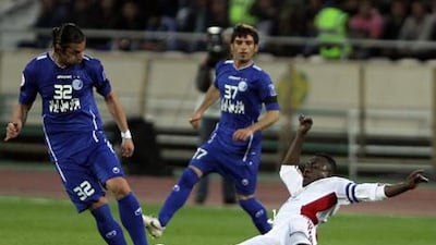 Ferdoon Zandi of Esteghlal is challenged by Al Jazira's Ibrahim Diaky during their 2012 Champions League clash.
