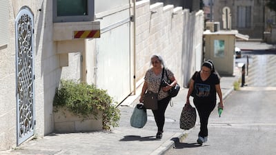 Staff leave the British Consulate General building in East Jerusalem. EPA