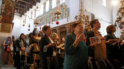 Worshippers pray as they attend the first Sunday mass at the Church of the Nativity after its reopening, as Palestinian authorities eased coronavirus restrictions, in the occupied West Bank town of Bethlehem. AFP