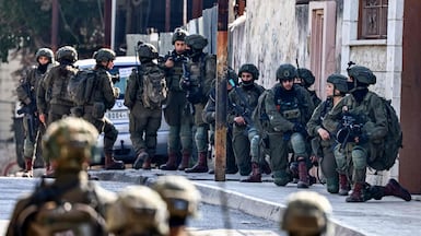 Israeli soldiers take positions during a military operation in the occupied West Bank. AFP
