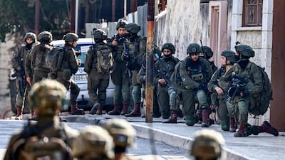 Israeli soldiers take positions during a military operation in the occupied West Bank. AFP