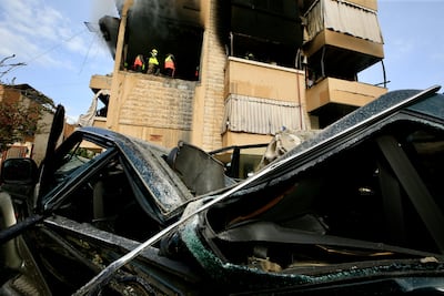 Responders at the site of the Israeli air strike in Sidon, which killed a family of four. EPA