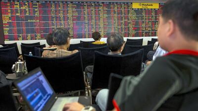 Thai investors monitor trading in Bangkok. The Thai SET index closed down 3.8 per cent on Monday, an 18-month year low. Athit Perawongmetha / Reuters