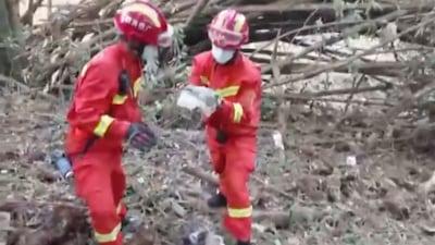 A screengrab from video by state broadcaster CCTV) shows rescue workers searching the crash site. AFP