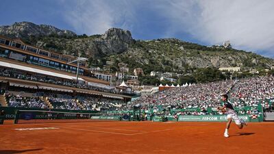 Novak Djokovic of Serbia, right, returns the ball to Pablo Carreno-Busta of Spain during their match on the central court at the Monte Carlo Masters in Monaco on April 17, 2014. REUTERS/Eric Gaillard