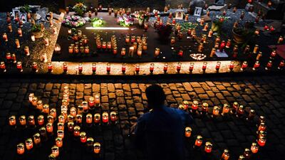 Candles, flowers and portraits are displayed at the Love Parade Memorial in Duisburg, western Germany, on the eve of the day marking 10 years after a mass panic broke out among ravers in a crowded tunnel at the Love Parade grounds, leaving 21 young people dead. AFP