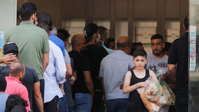 People queue to buy bread at a bakery in Beirut, June 27, 2020. Reuters