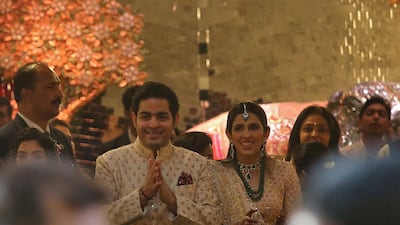 Akash Ambani with fiancee Shloka Mehta greet guests at the ceremony. Reuters
