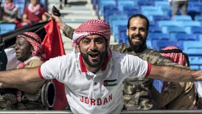 A Jordanian supporter cheers his side on from the stand.