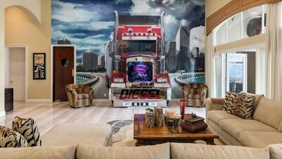 he symbol takes on its most dramatic avatar when embedded into a three-dimensional wall mural, which features a true-to-size tractor trailer barrelling down an expressway, seemingly towards the interior of the living room. The truck’s front cab – with a fish-tank-shaped Superman grille and a gleaming fender with the word Diesel (another of the NBA champion’s nicknames) emblazoned across it – juts out of the wall and into the living space, which is furnished with in-built double sofas. Painted on to the driver’s seat? A serious-looking Shaquille O’Neal himself.