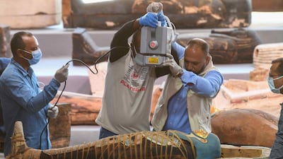 Archaeologists x-ray a mummy, wrapped in a burial shroud adorned with brightly coloured hieroglyphics pictorials. AFP