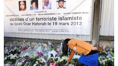 The killings by Mohamed Merah shocked France and led to an outpouring of public grief, including floral tributes at the Ozar Hatorah Jewish school where four of the victims died. Above, a French scout leaves flowers at the end of a march by people from all faiths yesterday in the city of Toulouse.