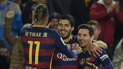 Luis Suarez, centre, celebrates with Neymar and Lionel Messi. Lluis Gene / AFP