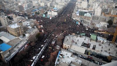 Iranians march behind a vehicle carrying the coffins of Qassem Suleimani and others as they pay homage in the northeastern city of Mashhad. AFP