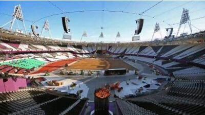 Torchbearer Austin Playfoot lights the Olympic Cauldron during a ceremony at the Olympic stadium in London.