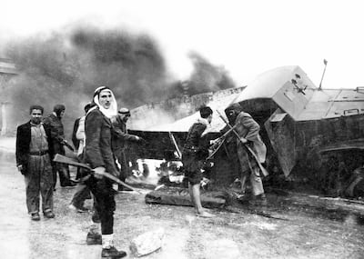 Palestinian fighters beside a burned-out Israeli Haganah supply truck near Jerusalem during the 1948 Arab-Israeli War. Getty Images