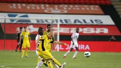Mariano Donda, front, passes the ball under pressure from Al Jazira's Ibrahim Diaky as Al Wasl won 3-2 in Abu Dhabi last night. Pawan Singh / The National