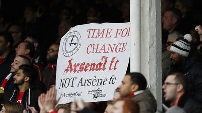 Arsenal fans with a banner regarding Arsenal manager Arsene Wenger, Reuters / Phil Noble