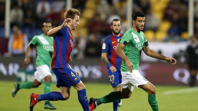 Barcelona’s Ivan Rakitic fights for the ball with Al Ahli’s Omar Al Soma. Ibraheem Al Omari / Reuters