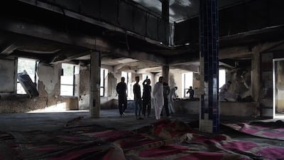 Afghan men inspect the interior of a Shiite mosque a day after a suicide attack on the premises in Kabul on August 26, 2017. Shah Marai / AFP