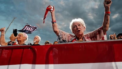 People cheer for US President Donald Trump at a campaign rally at Cecil Airport in Jacksonville. Reuters