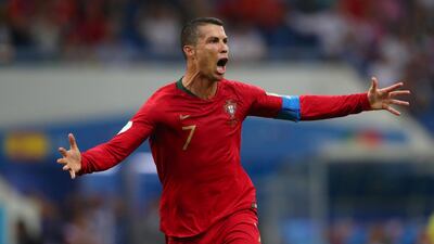 Portugal's Cristian Ronaldo wheels away in celebration after his free kick found the back of the net, giving his team a 3-3 draw and himself a World Cup hattrick. Hannah McKay / Reuters