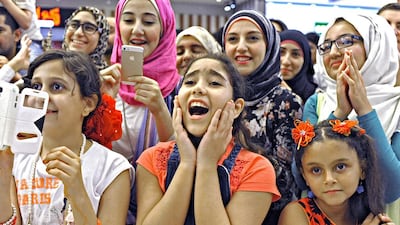 Yomna Al Faham, front centre, reacts happily as she listens to singer Diana Haddad perform at Fujairah's City Centre Mall on October 31. Photo by Jeff Topping For The National.