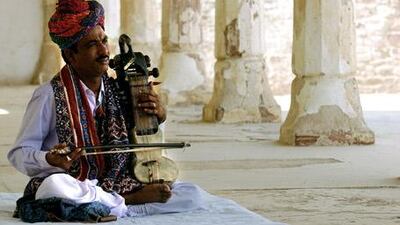A Rajasthani musician performs while Britain's Prince Charles tours Nagaur Fort in the Indian state of Rajasthan.