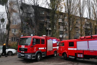 Firefighters work to put out a fire in a residential building in Kyiv hit by a Russian strike, on November 15. Reuters