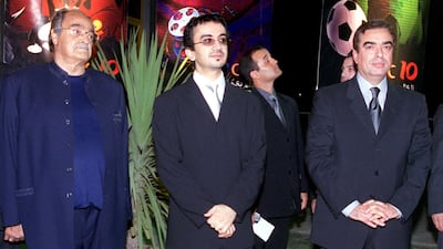 Saleh Kamel, left, poses with chairman of London-based MBC satellite TV station Sheikh Walid el-Barahim, centre, and Lebanese TV presenter George Qurdahi during MBC's 10th anniversary at Forum de Beirut, on September 18, 2001. AFP