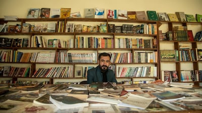 Kamiran Khalaf sitting in the middle of his newly opened bookstore in the city of Sinjar in northern Iraq. Haider Husseini for The National