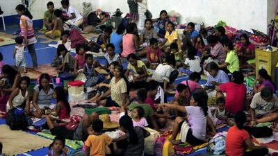Evacuees from the coastal villages take shelter inside an evacuation centre as Typhoon Haima locally name Lawin approaches, in Alcala town, Cagayan province, north of Manila. Reuters
