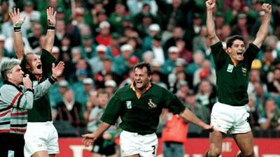 Joost van der Westhuizen, right, celebrates with Francois Pienaar, left, and Ruben Kruger, who has since died after a long battle with brain cancer, after winning the World Cup in 1995