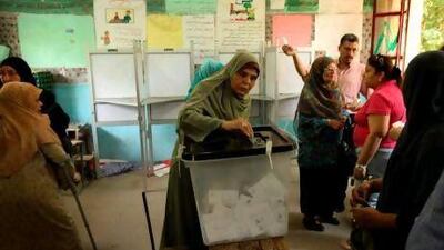 An Egyptian woman casts her vote at a polling station in Cairo yesterday. Egyptians were voting in the second and last day of a highly divisive presidential election.