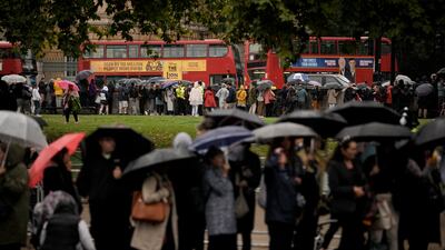 Mourners queue in the streets waiting for the hearse to pass. AP