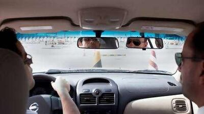 Kareem tries hard to focus on the mirror as his instructor takes him through a spot of parking.