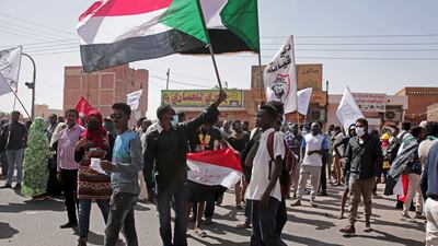 People wave flags as they march. AP