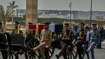 A horse-drawn carriage carries the flag-draped coffin of former president Hosni Mubarak during his funeral at Tantawi Mosque. AP Photo