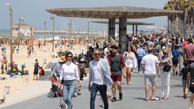 People without face masks enjoy the weather on the beach of Tel Aviv. EPA